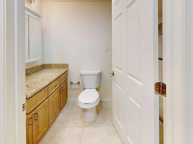 Bright and inviting bathroom with elegant granite countertop and modern fixtures.