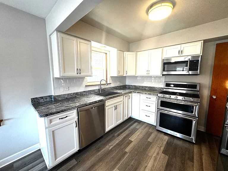 stunning new kitchen with upgraded stainless steel appliances,