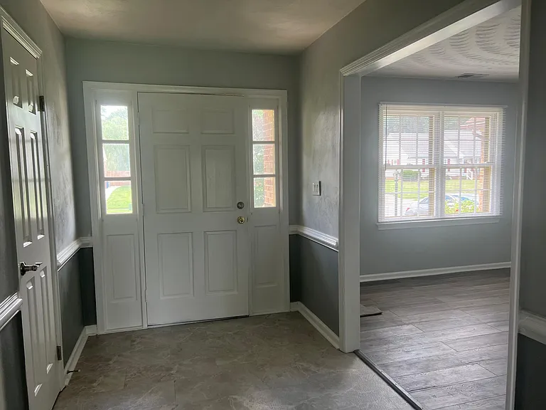Large foyer leads to a large living room, dining room and hall to the bedrooms.