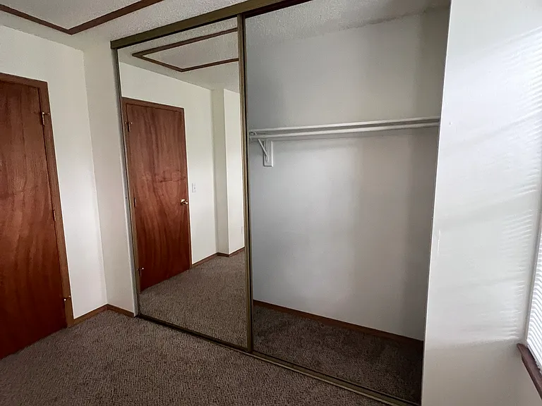 Second bedroom large closet with mirrored sliding doors