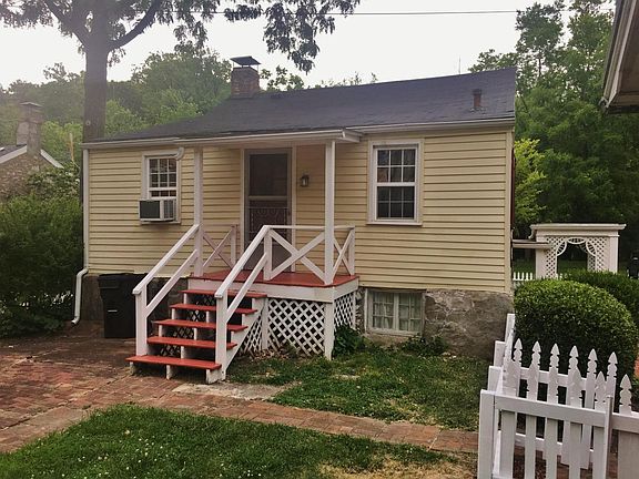 Rear of Home With Pergola and Picket Fence