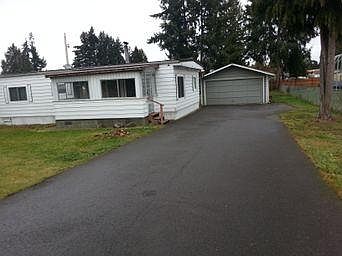 Front of House, three car drive way and two car garage