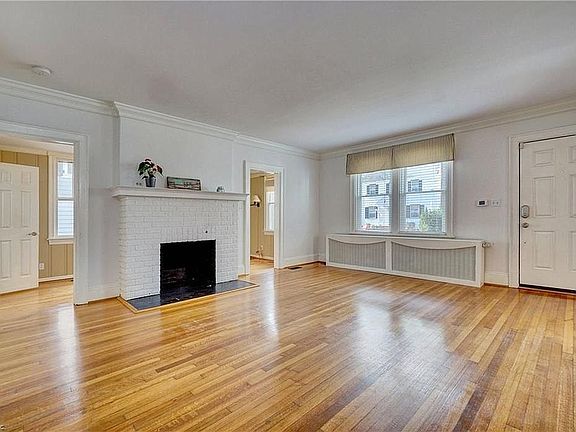 Living room w/ wood burning fireplace.