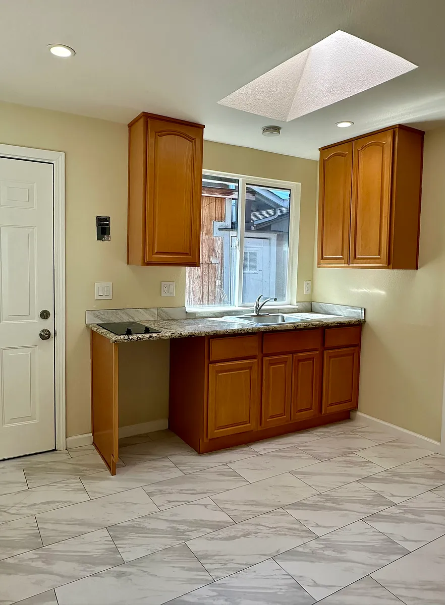 Kitchenette area with electric cooktop, recessed lighting and skylight - 2671 Hawthorne Ave