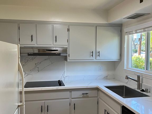 Updated kitchen with Quartz counter top, new cook top, stove.