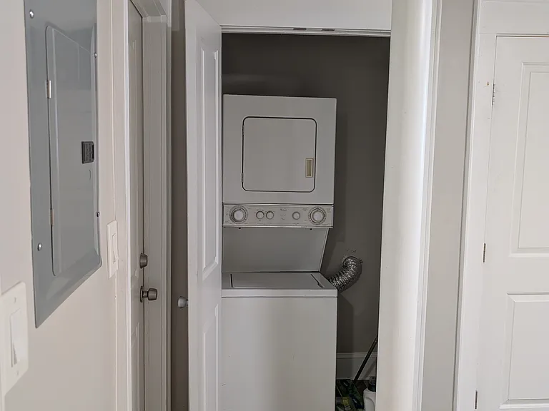 View of stacked laundry laundry washer and dryer