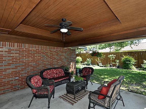 This is a view of the covered back patio. The coffered stained wood ceiling is just a little bonus out back. You could spend hours sitting back here, under the ceiling fan watching the local owls and other birds.