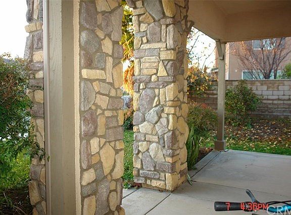 Front porch with wrapped around stone accents.