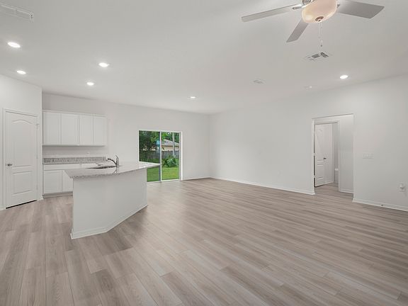 The family room is spacious and has a sliding glass door leading to the backyard