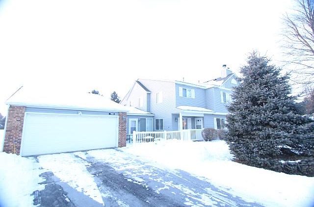 Front of Townhome showing nice yard and attached double garage.