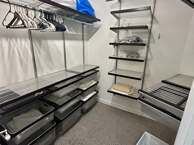Massive walk-in closet with custom Elfa shelving.