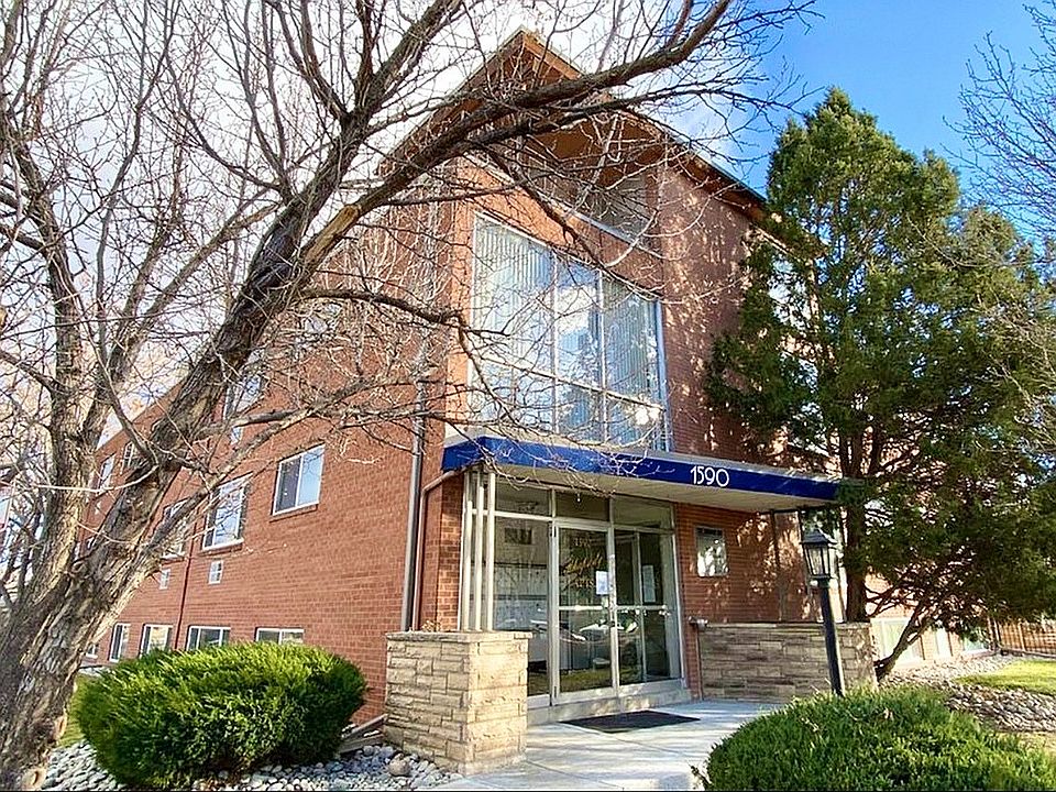 Welcome to your new home! This charming brick exterior offers a cozy facade framed by beautiful trees.