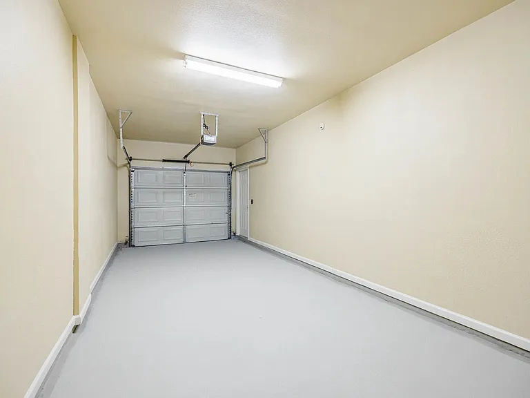 Spacious and clean single-car garage with bright lighting and freshly painted walls, perfect for parking or storage. Spacious and clean single-car garage with bright lighting and freshly painted walls, perfect for parking or storage.