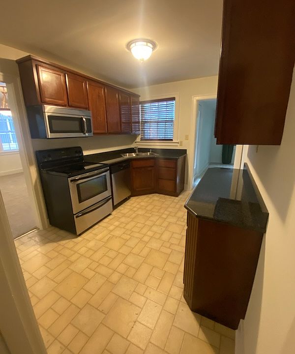 Kitchen from hallway entrance, granite countertops, stainless steel appliances