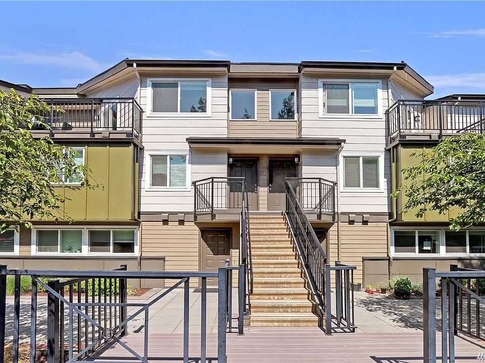 Unit is the second story front door with balcony on the top right