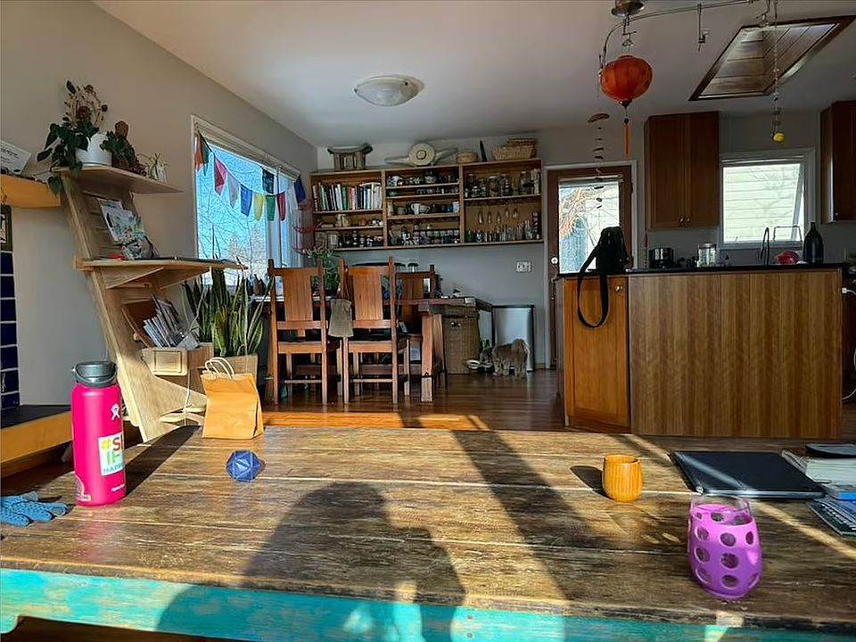 view of kitchen island and dining area from upstairs couch