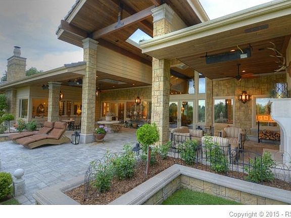Amazing back patio with stone floor, fireplace & wood ceiling with heaters, fans and skylight.