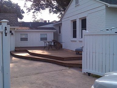 Split-level deck in fenced yard.