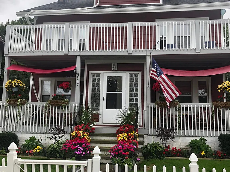 Exterior view of home. Unit's Third floor living room windows at very top dormer
