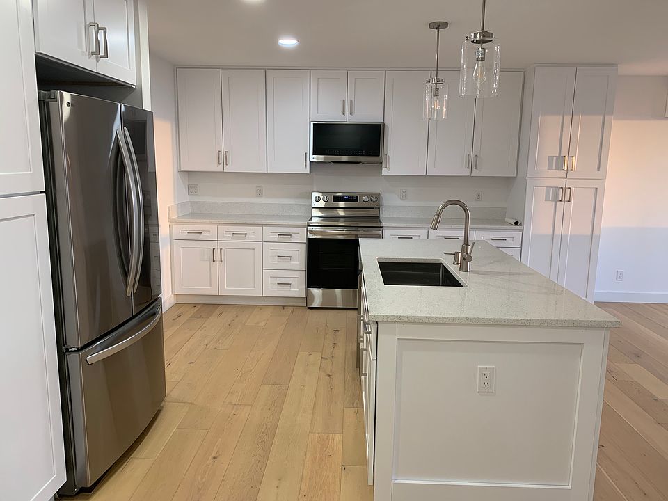 2nd floor: kitchen with quartz countertops and stainless steel appliances.