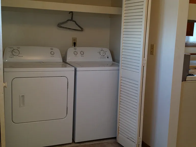 Laundry closet with washer and dryer. Located off of the kitchen and dining area.