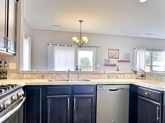 BEAUTIFUL AND WARM OPEN CONCEPT MFLOOR w/UPGRADED WOOD FLOORING, CABINETS, BREAKFAST BAR, STAINLESS STEEL APPLIANCES, LIGHTING, CARPET & MORE!