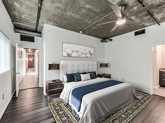 A view of the large primary bedroom that has updated Bamboo flooring. This is a virtually staged photograph.