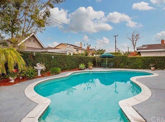 Refreshing pool in 'secret garden' style backyard - time for a soothing swim!