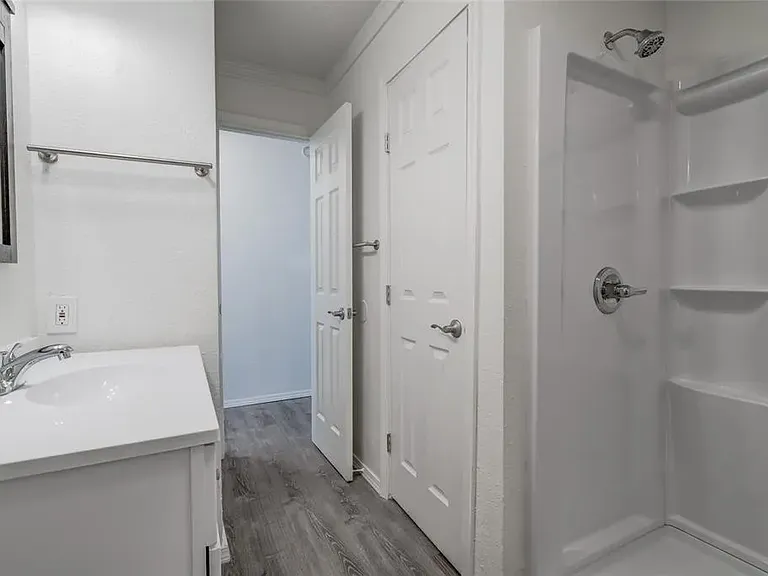 Large bathroom with 60" step in shower. Linen closet