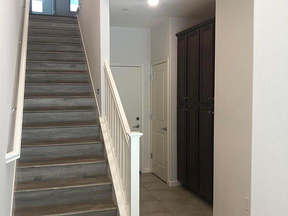 First floor stairs storage cabinets full bath bedroom. door to the garage