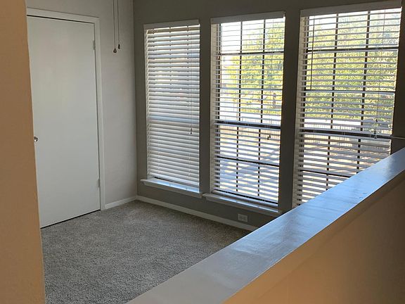2nd bedroom .natural light . Half wall open to the stairwell.