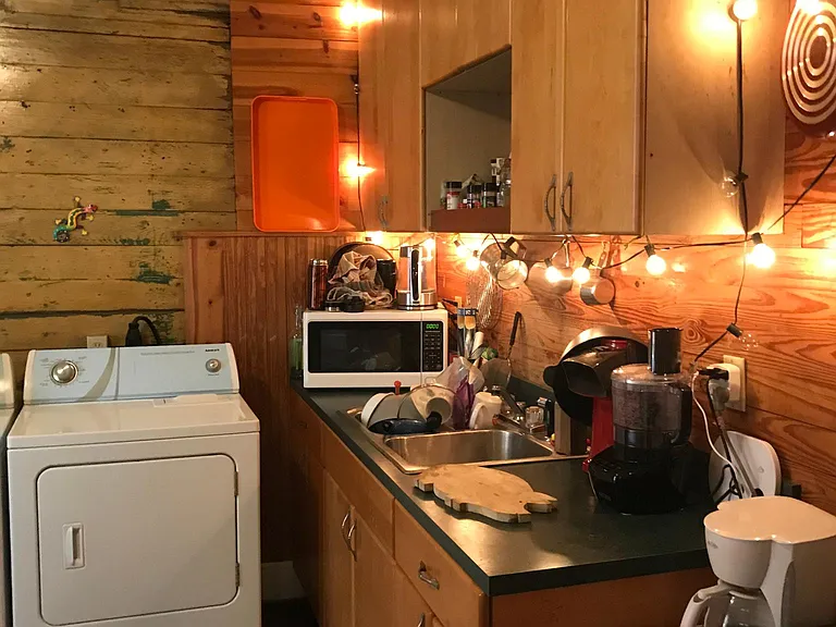 Kitchen with maple cabinets and washer - dryer
