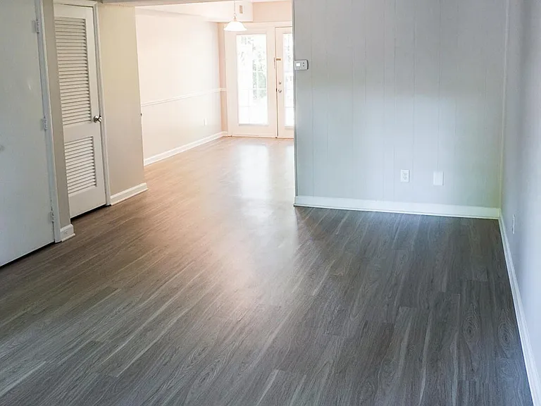 Select apartments feature upgraded hardwood plank flooring on the ground level.