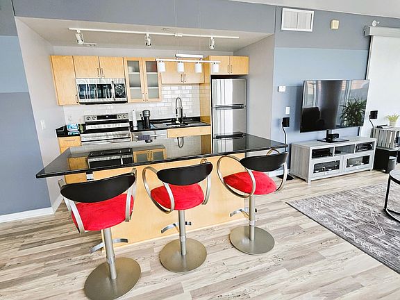 Kitchen has maple cabinets accentuated with granite counters and stainless steel appliances