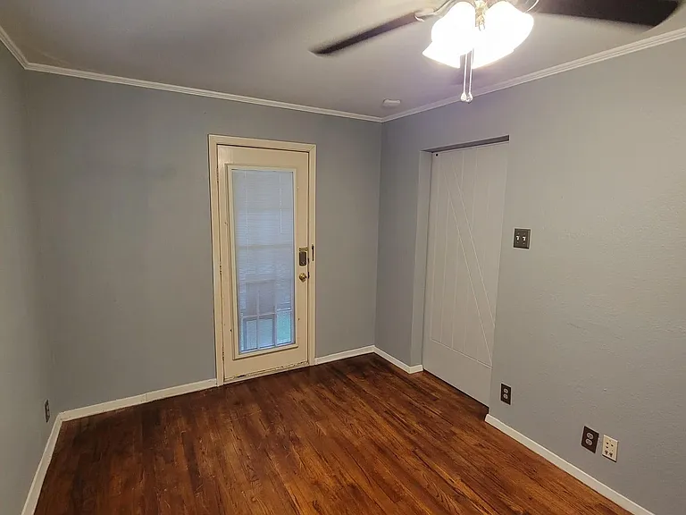 Bedroom with door to outside patio. Doggie dog is installed now.