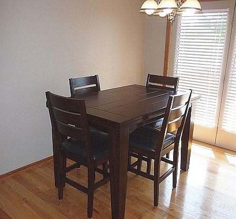 Dining area, like kitchen, features hardwood flooring