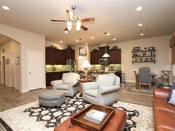 Wood like tile throughout downstairs, Granite countertops, Island Kitchen with stainless appliances! Wall of windows!