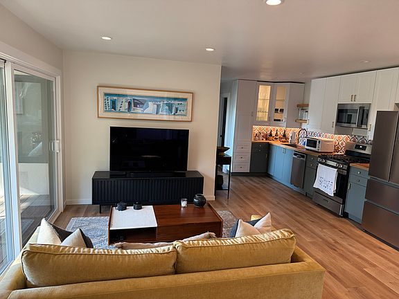 Integrated, open concept, living room & kitchen layout. View from entry/mud room