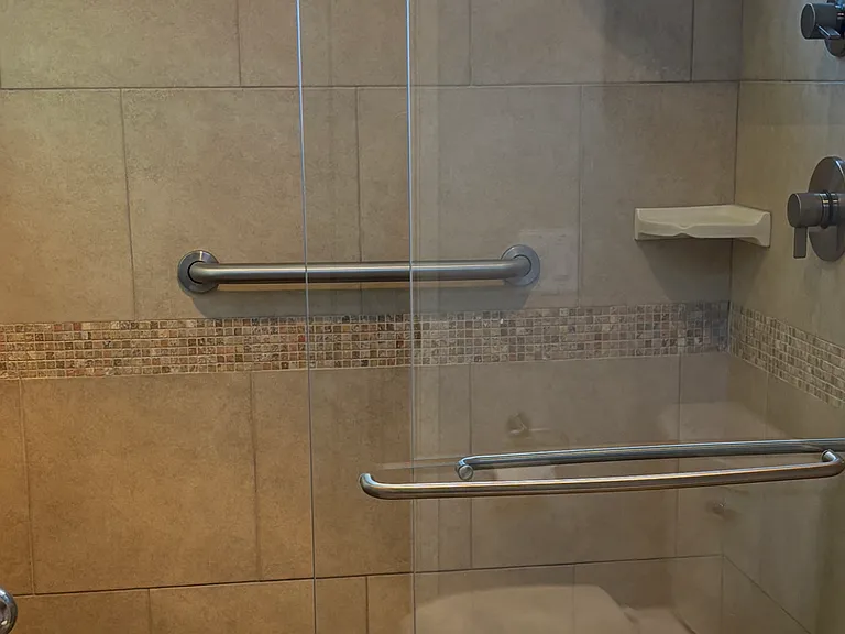Main Bedroom bathroom walk in shower with hand bars.