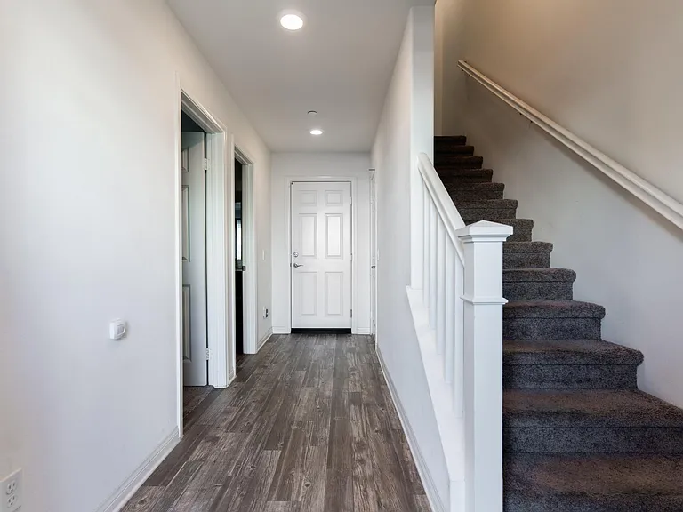 Ground floor, front door entry way with entrance to the garage and one bedroom + bathroom.