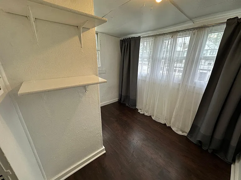Bedroom, black out curtains and sheer curtains provided, light filled room. 
East and north facing windows.