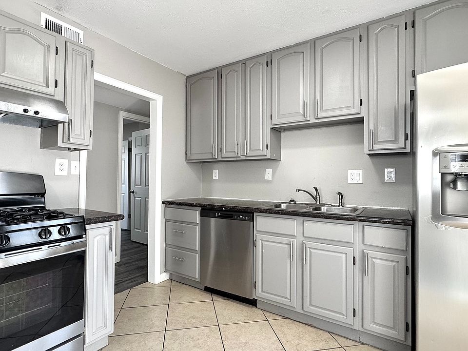 Modern kitchen with sleek stainless steel appliances, elegant gray cabinetry, and generous counter space for a stylish and functional cooking experience.
