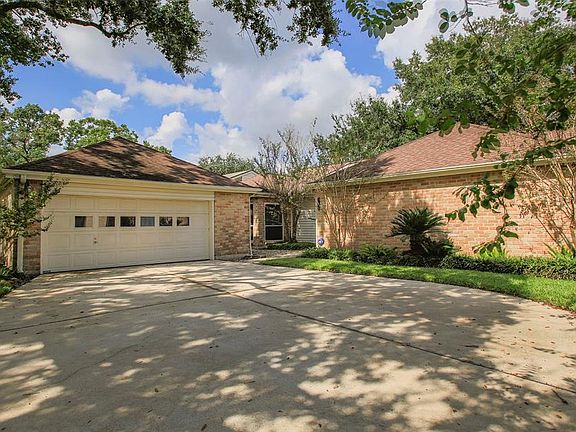 The wide driveway leading to the two car garage offers extra parking for your guests. The garage is detached, but there is a covered walkway into the side entrance of the home.