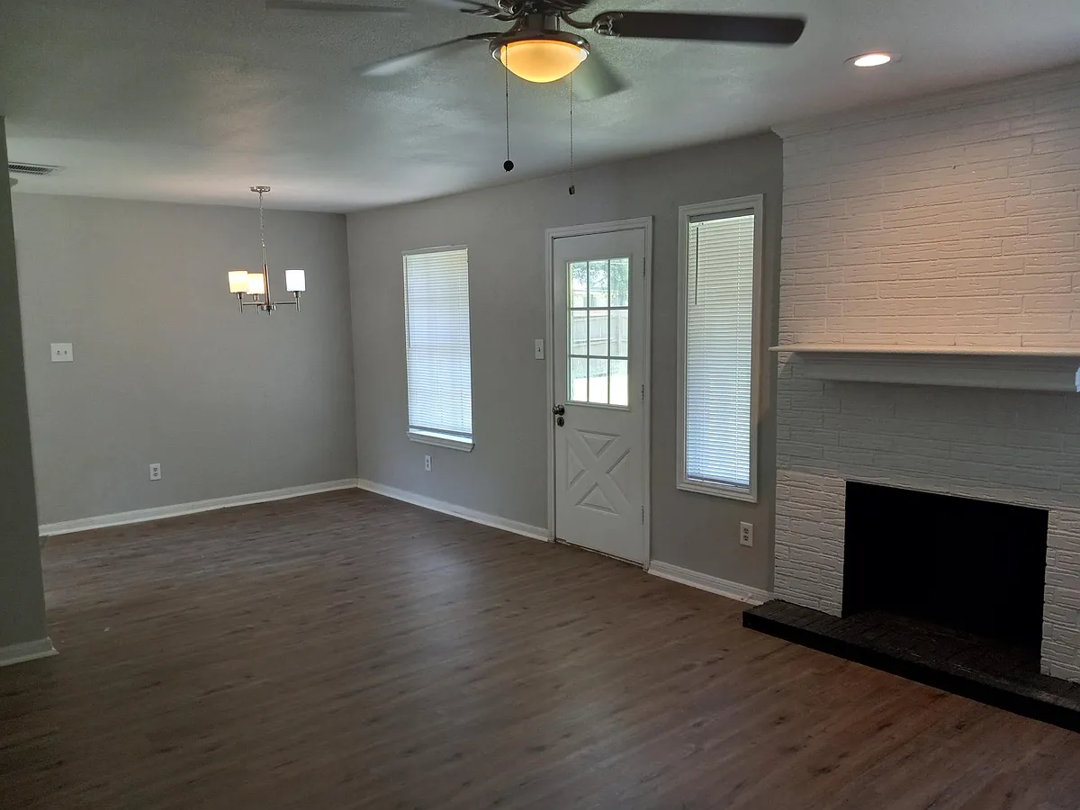 Large living and dining space opening into your huge backyard with covered patio. - 601 Oakridge Cir