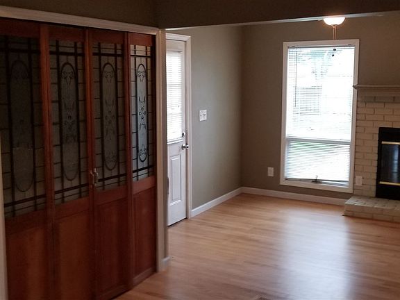 Open kitchen with dining area and decorative fireplace.