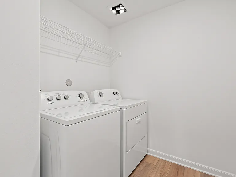 Additional storage above the washer and dryer.