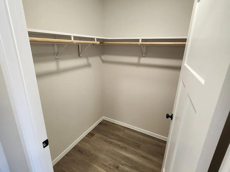 Closet space off the hallway from the garage entrance into kitchen. (Pictures are of another unit with similar finishes and features.)