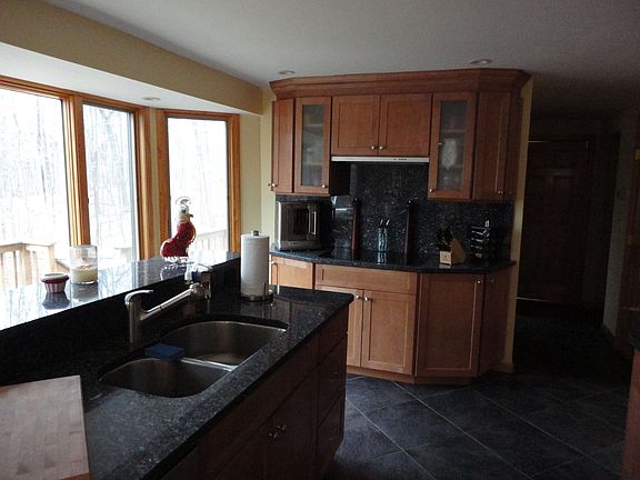 Kitchen has large bay window, stove top cook center