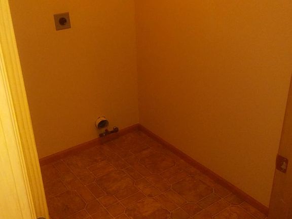 Washer Dryer hook ups in separate room w/door.