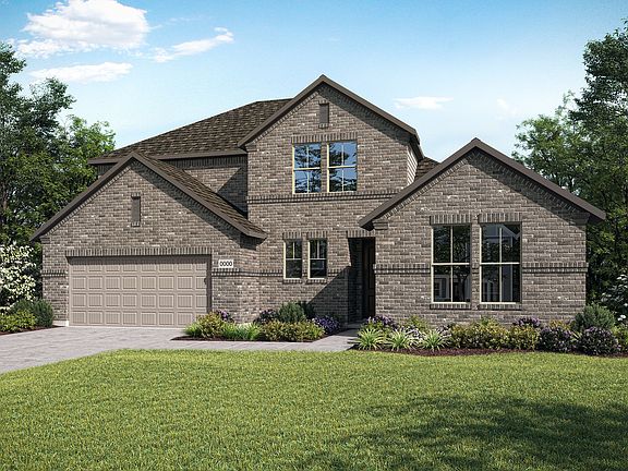 A two-story brick house with a gabled roof and a well-manicured lawn surrounded by trees stands in a